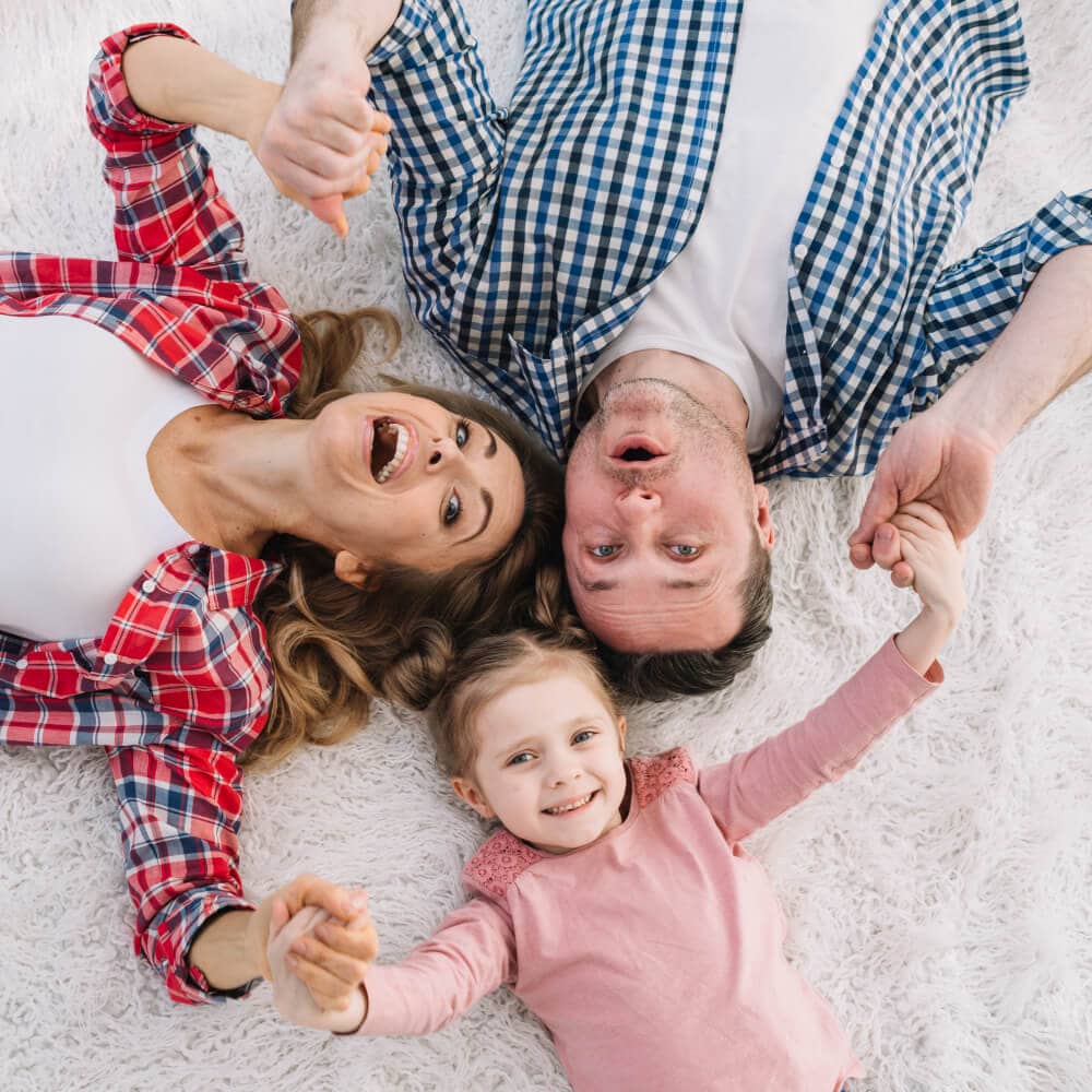 happy family lying in furry carpet