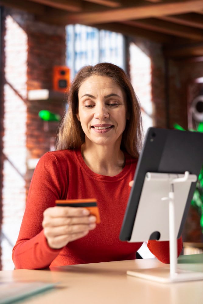 Smiling woman entering her credit card Freepik