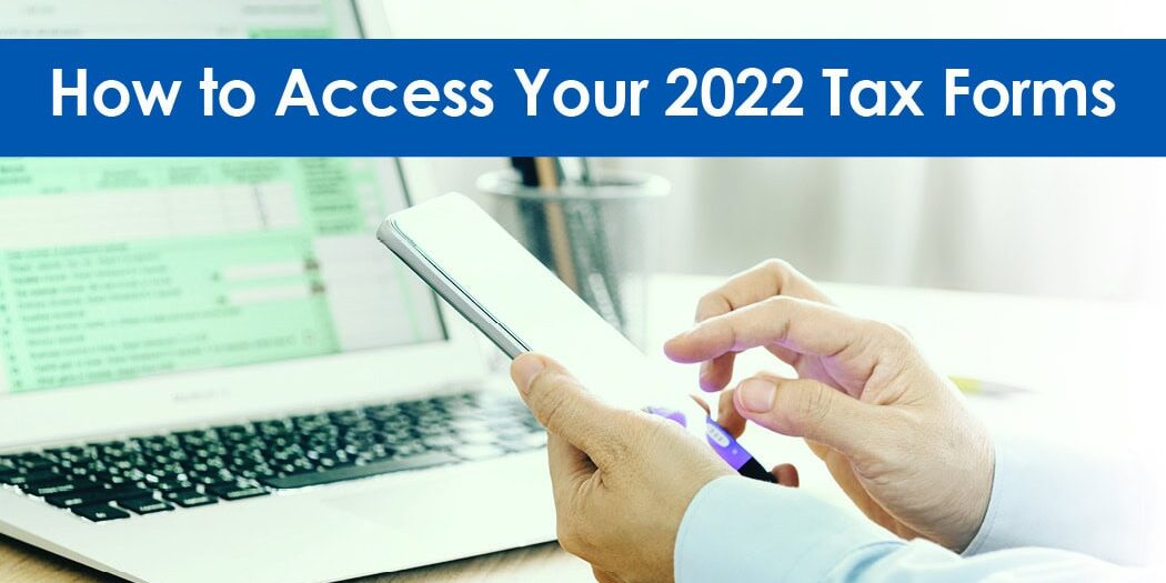 hands holding cell phone near laptop with tax document on screen